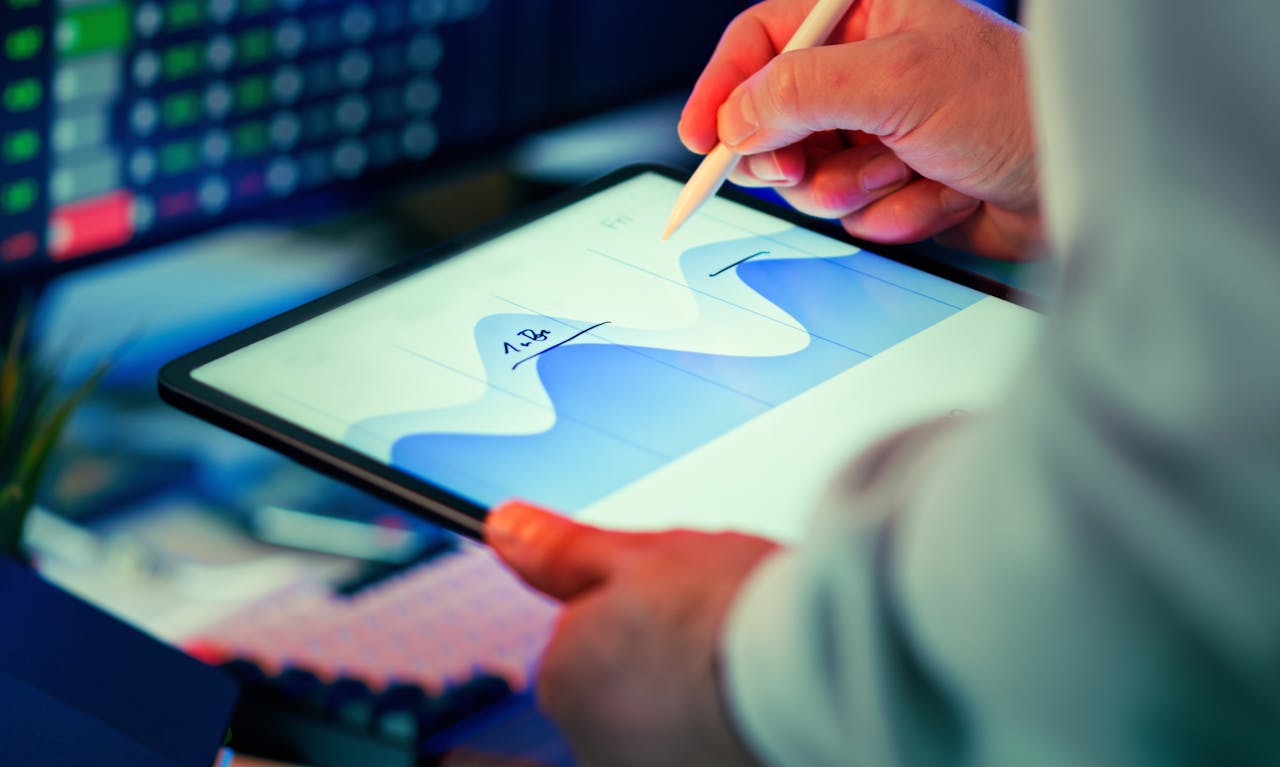 services-03 Professional analyzing data chart on a tablet with stylus in an office setting.